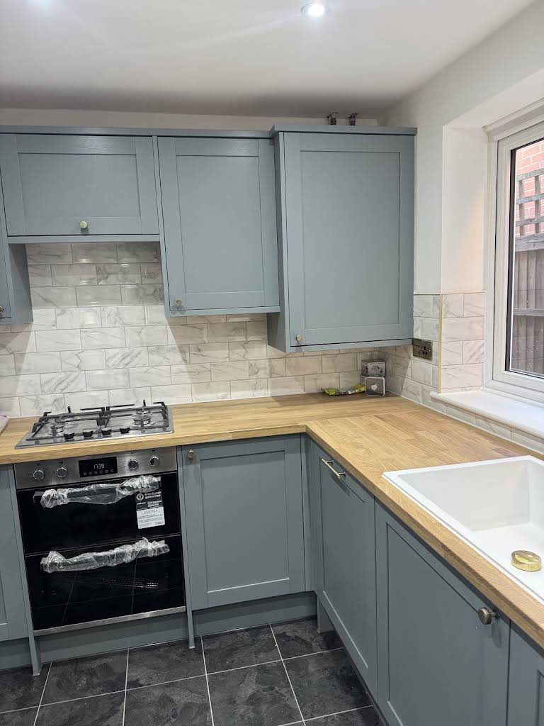 Finished shaker-style kitchen renovation with marble splashback by JCL Renovations, St Albans
